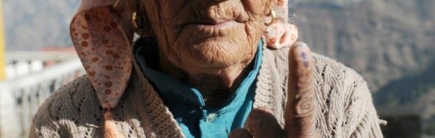 An elderly voter showing her marked finger after casting her vote at a...