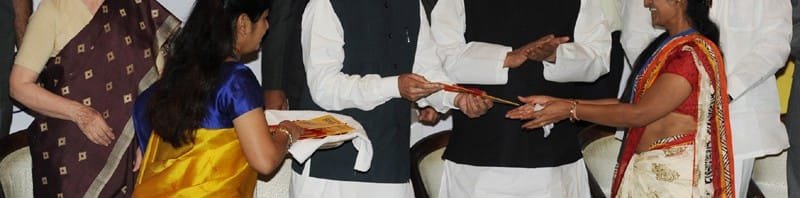 The Prime Minister, Dr. Manmohan Singh presents the new account kit to the first...