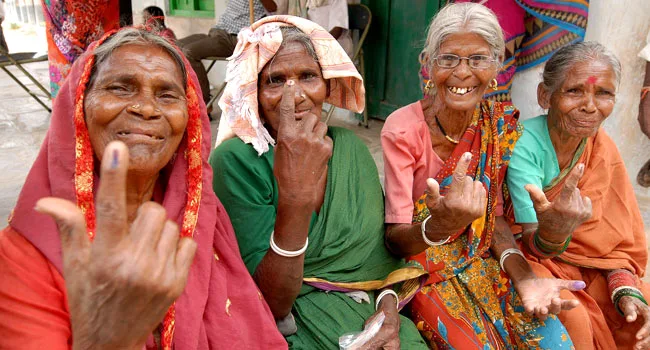 The elderly female voters showing mark of indelible ink after cast their votes,…