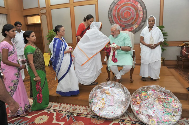 Widows from Vrindavan and Varanasi tying ‘Rakhi’ to the Prime Minister,…