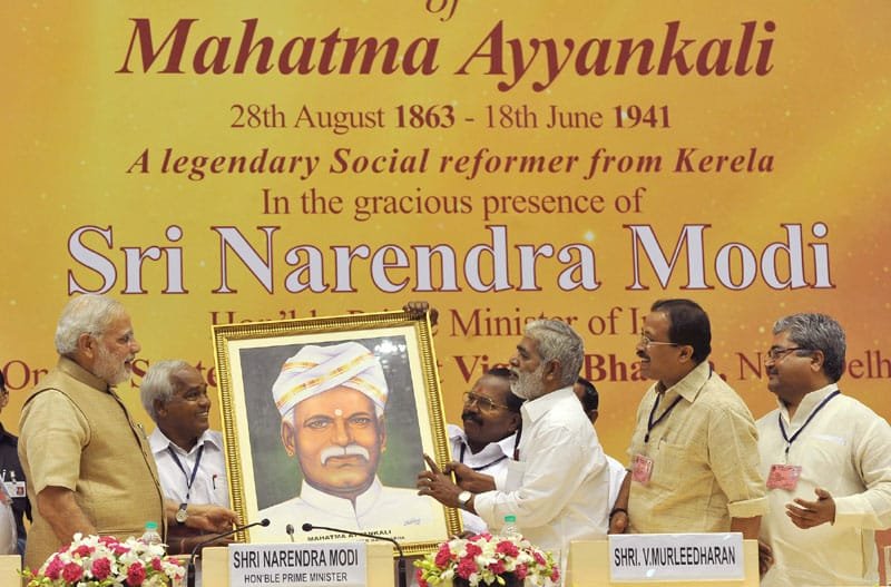 The Prime Minister, Shri Narendra Modi being presented a portrait of Mahatma...