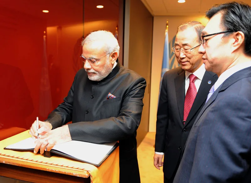 The Prime Minister, Shri Narendra Modi signing the visitor's book at the...