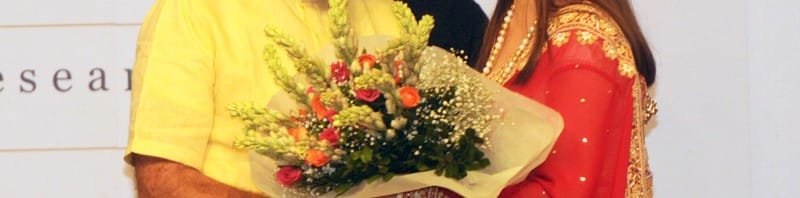 The Prime Minister, Shri Narendra Modi being presented a bouquet of flowers by...