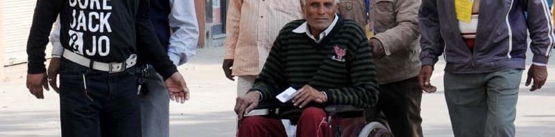 A physically handicapped voter being carried at a polling booth to ...