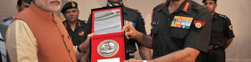 The Prime Minister, Shri Narendra Modi being presented a memento by the ...