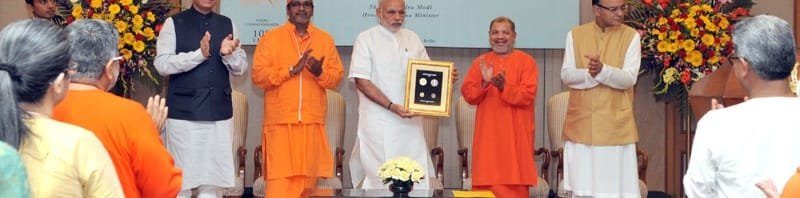 The Prime Minister, Shri Narendra Modi releasing a commemorative coin to ..