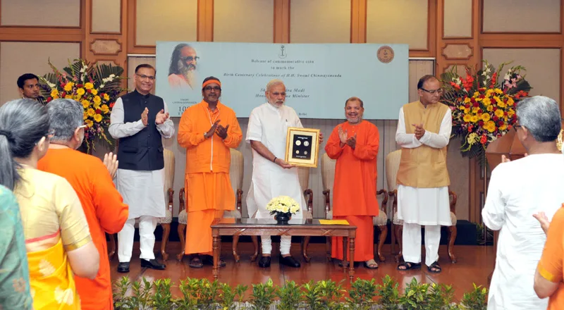 The Prime Minister, Shri Narendra Modi releasing a commemorative coin to ..