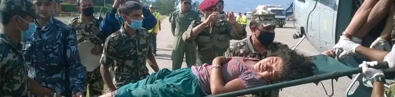 An injured woman being taken to a safer place boarding by an Indian Air Force..
