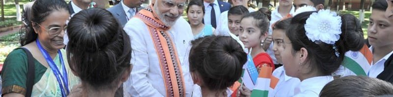 The Prime Minister, Shri Narendra Modi interacting with the children after paying tributes, ..