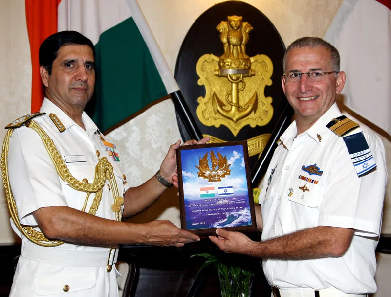 The Chief of Naval Staff, Admiral R.K. Dhowan exchanging the memento with the..