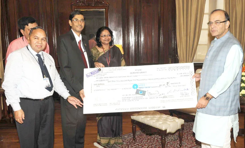 The CMD, State Bank of Hyderabad, Shri Santanu Mukherjee presenting a cheque to..