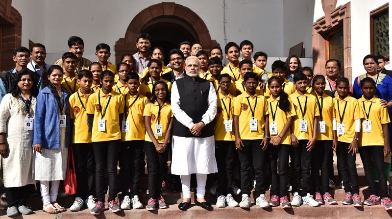 The Prime Minister, Shri Narendra Modi with a group of underprivileged students..